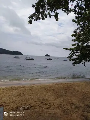 a group of boats in the water on a beach at Pangkor fun fun fun apartment in Pangkor
