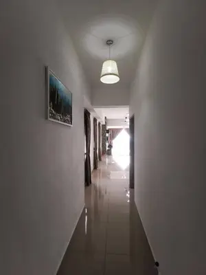 a long hallway with a picture on the wall at The Venus Sitiawan Breezee Spacious Homestay 6 to 8 Pax in Kampong Lumut Kiri