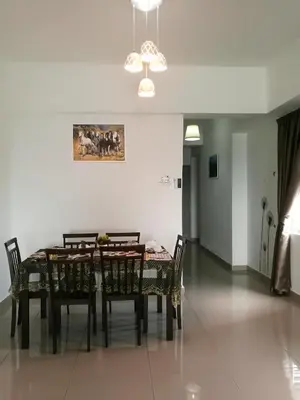 a dining room table with chairs and a painting on the wall at The Venus Sitiawan Breezee Spacious Homestay 6 to 8 Pax in Kampong Lumut Kiri
