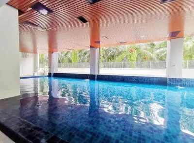 a large swimming pool with a large window in a building at The Venus Sitiawan Breezee Spacious Homestay 6 to 8 Pax in Kampong Lumut Kiri