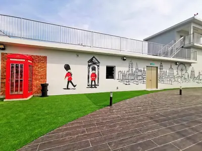 a mural on the side of a building with a red phone booth at The Venus Sitiawan Breezee Spacious Homestay 6 to 8 Pax in Kampong Lumut Kiri