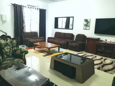 a living room with a couch and a tv at Homestay Sungai Besar, Tmn Yu in Sungai Besar
