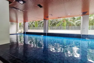 an indoor swimming pool with blue water in a building at The Venus Sitiawan Spacious High Floor Homestay 6 to 10 Pax in Kampong Lumut Kiri