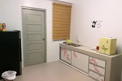 a kitchen with a sink and a refrigerator at The Venus Sitiawan Spacious High Floor Homestay 6 to 10 Pax in Kampong Lumut Kiri
