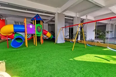 a play area with a playground with a slide at The Venus Sitiawan Spacious High Floor Homestay 6 to 10 Pax in Kampong Lumut Kiri