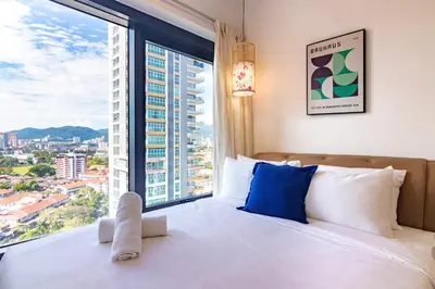 a bedroom with a bed and a large window at ❈ Tropicana 218 by ALV Suites ❈ in George Town