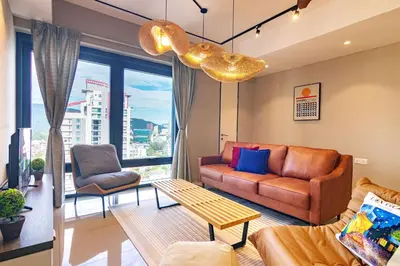 a living room with a couch and a table at ❈ Tropicana 218 by ALV Suites ❈ in George Town