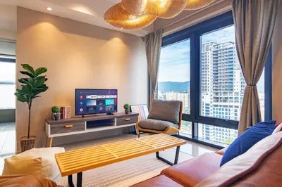 a living room with a tv and a large window at ❈ Tropicana 218 by ALV Suites ❈ in George Town