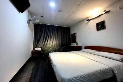 a bedroom with a large bed and a window at Madani Muslim Hotel Cameron Highland in Cameron Highlands