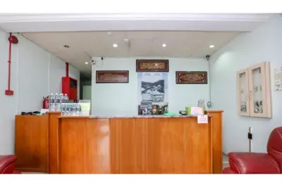 a bar in a restaurant with red chairs at Madani Muslim Hotel Cameron Highland in Cameron Highlands