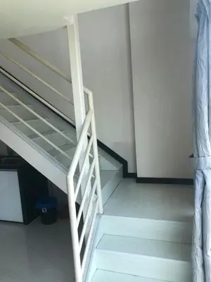 a staircase in a room with a bunk bed at The Ceo Suites in Bayan Lepas