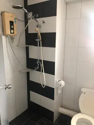 a bathroom with a black and white striped wall at The Ceo Suites in Bayan Lepas