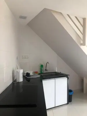 a kitchen with a sink and a counter top at The Ceo Suites in Bayan Lepas