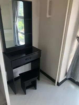 a black dresser with a mirror in a room at The Ceo Suites in Bayan Lepas