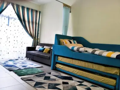 a living room with a blue bed and a couch at MiahPuteh Cozy Homestay Cameron Highlands Pasar Malam in Brinchang