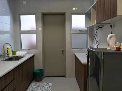 a kitchen with a refrigerator and a sink and windows at MiahPuteh Cozy Homestay Cameron Highlands Pasar Malam in Brinchang