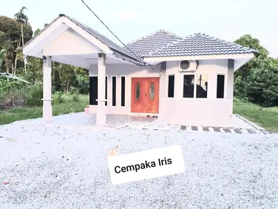 a small house with a sign in front of it at CEMPAKA IRIS HOMESTAY in Kampung Bota Kiri