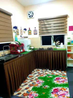 a kitchen with a counter with a rug on the floor at CEMPAKA IRIS HOMESTAY in Kampung Bota Kiri