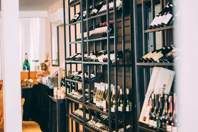 a room filled with bottles of wine on a shelf at Seriental Hotel I check in 3pm-11pm only in Tanjong Tokong