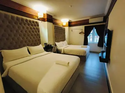 a hotel room with two beds and a window at Seriental Hotel I check in 3pm-11pm only in Tanjong Tokong