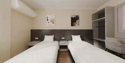 a room with two beds and a chair at VISTA HOTEL in Kampar