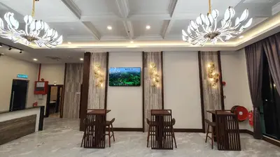 a lobby with chairs and chandeliers at VISTA HOTEL in Kampar