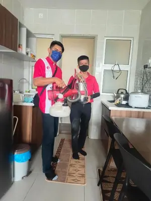 two men standing in a kitchen with masks on at LOVE LODGE BRINCHANG, CAMERON HIGHLANDS in Tanah Rata