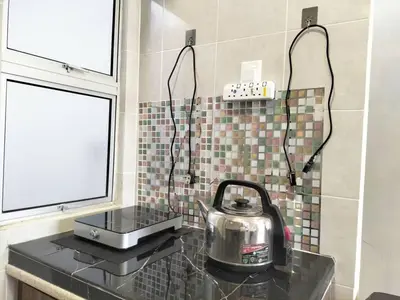 a tea kettle on a counter in a kitchen at LOVE LODGE BRINCHANG, CAMERON HIGHLANDS in Tanah Rata