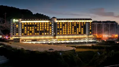 a large building with yellow lights on it at night at Hills Aranda Nova Hotel in Cameron Highlands