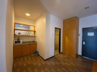 an empty room with a kitchen with a microwave at Hills Aranda Nova Hotel in Cameron Highlands
