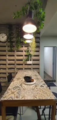 a dining room with a table and a clock at Room at Lebuh Armenian Georgetown City Center in George Town