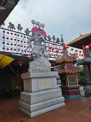 a statue in front of a building with a sign at Room at Lebuh Armenian Georgetown City Center in George Town