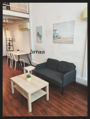 a living room with a couch and a table at The ceo suites by Zenbnb in Bayan Lepas