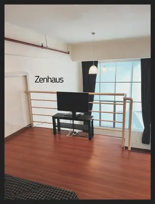 a living room with a computer sitting on a wooden floor at The ceo suites by Zenbnb in Bayan Lepas