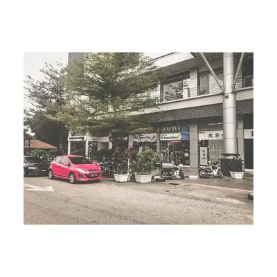 a red car parked in front of a building at The ceo suites by Zenbnb in Bayan Lepas