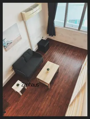 a living room with a black couch and a table at The ceo suites by Zenbnb in Bayan Lepas