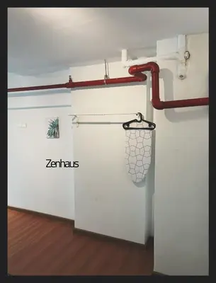 a white door with a red pipe on the wall at The ceo suites by Zenbnb in Bayan Lepas