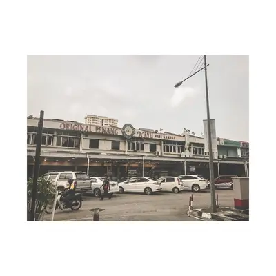 a building with cars parked in a parking lot at The ceo suites by Zenbnb in Bayan Lepas