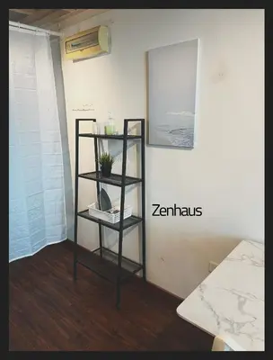 a black shelf with a plant on a wall at The ceo suites by Zenbnb in Bayan Lepas