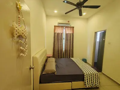 a bedroom with a bed and a ceiling fan at Teluk Batik 17ParadiseHome Private Pool Karaoke Snooker BBQ 15pax in Lumut