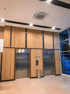 a row of elevators in a building with wooden walls at Kingston Hotel 13 - Penang Hills formerly known as Deview Hotel in Ayer Itam