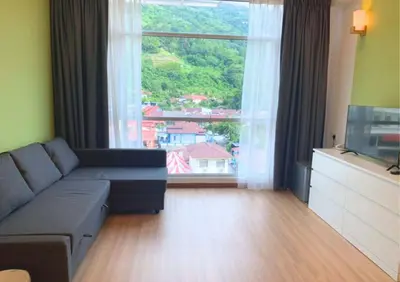 a living room with a couch and a large window at Kingston Hotel 13 - Penang Hills formerly known as Deview Hotel in Ayer Itam