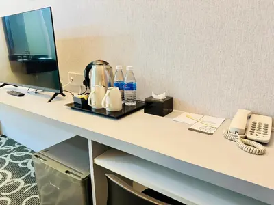 a desk with a computer and a phone on it at Kingston Hotel 13 - Penang Hills formerly known as Deview Hotel in Ayer Itam