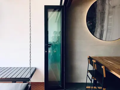 a dining room with a glass door and a table at 80 Colonie Fraser's Hill 8pax in Bukit Fraser