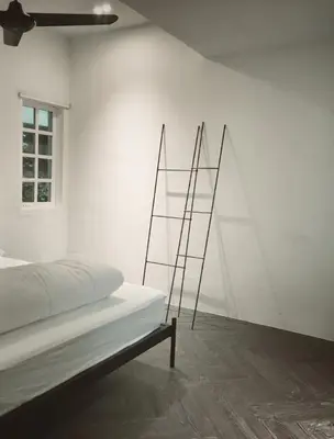 a white room with a bed and a ladder at 80 Colonie Fraser's Hill 8pax in Bukit Fraser