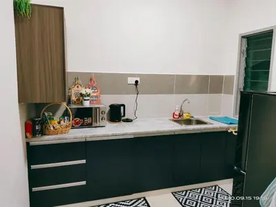 a kitchen with a sink and a counter top at HOMESTAY NazIPOH Meru in Ipoh