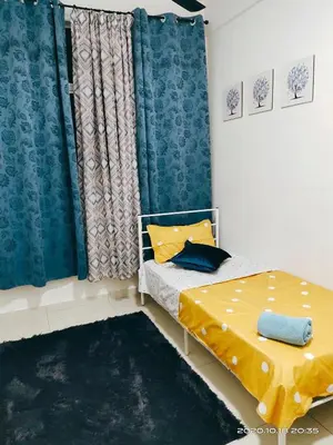 a small bedroom with a bed and a curtain at HOMESTAY NazIPOH Meru in Ipoh