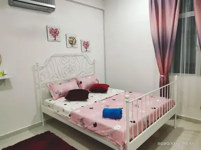 a bedroom with a white crib with pink sheets at HOMESTAY NazIPOH Meru in Ipoh