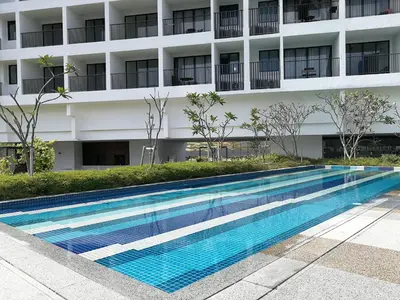 a swimming pool in front of a building at Landmark Lovely Coast View King Suite#500mbpsWifi#Netflix in Tanjong Tokong