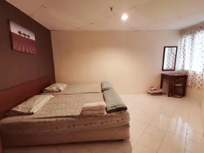 a bedroom with a large bed in a room at Pangkor Coral Bay Homestay 315 in Pangkor